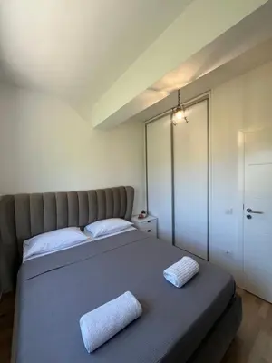 a bedroom with a bed with two towels on it at Apartments Nesi in Ulcinj