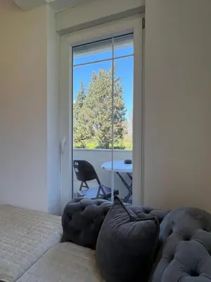 a room with a couch and a window with a view at Apartments Nesi in Ulcinj