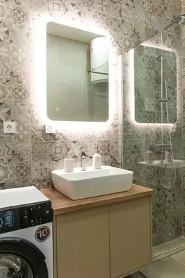 a bathroom with a sink and a washing machine at Konzul apartment in Kotor