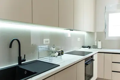 a kitchen with a sink and a dish rack on the counter at Konzul apartment in Kotor