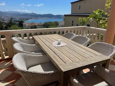 a wooden table and chairs on a balcony at Villa Sky Mountain in Bar