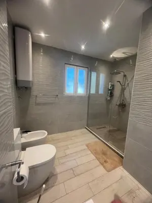 a bathroom with a shower and a toilet and a sink at Villa Sky Mountain in Bar