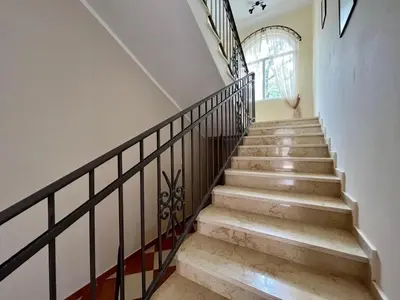 a staircase with a wrought iron railing and a window at Villa Sky Mountain in Bar
