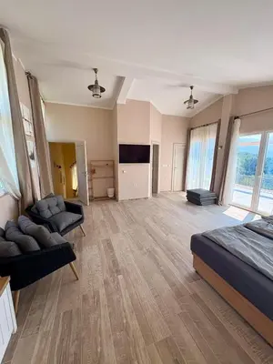 a large room with a bed and a flat screen tv at Villa Sky Mountain in Bar