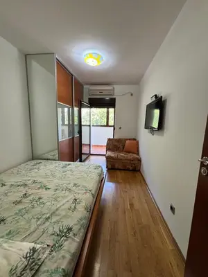 a bedroom with a bed and a couch in a room at GO COAST Petrovac in Petrovac na Moru