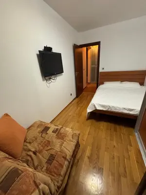 a bedroom with a bed and a tv on the wall at GO COAST Petrovac in Petrovac na Moru