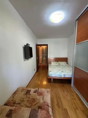 a bedroom with a bed and a flat screen tv at GO COAST Petrovac in Petrovac na Moru