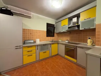 a kitchen with yellow cabinets and yellow counters at GO COAST Petrovac in Petrovac na Moru