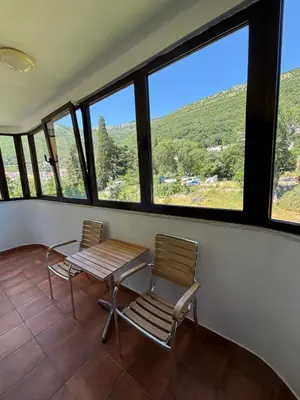 two chairs and a table in a room with windows at GO COAST Petrovac in Petrovac na Moru