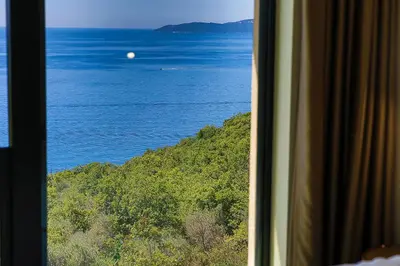a view of the ocean from a train window at Orange Tree Pool Villas - Sea View and Private Pool in Reževići