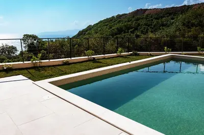 a swimming pool with a view of a mountain at Orange Tree Pool Villas - Sea View and Private Pool in Reževići
