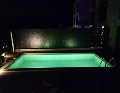 a swimming pool in a dark room at night at Orange Tree Pool Villas - Sea View and Private Pool in Reževići