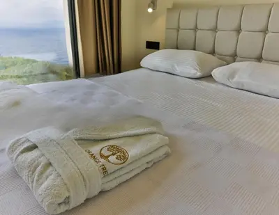 a bed with two towels on it with a window at Orange Tree Pool Villas - Sea View and Private Pool in Reževići