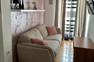 a living room with a couch and a table at Apartman Mimi in Budva