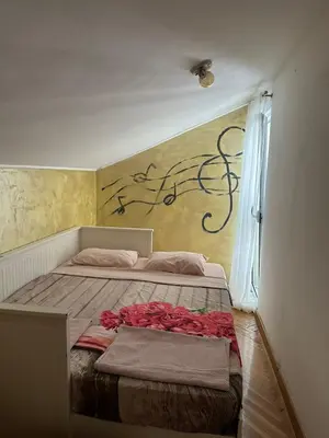a bedroom with a bed with roses on it at Apartman Mimi in Budva