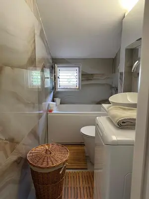 a bathroom with a tub and a toilet and a sink at Apartman Mimi in Budva
