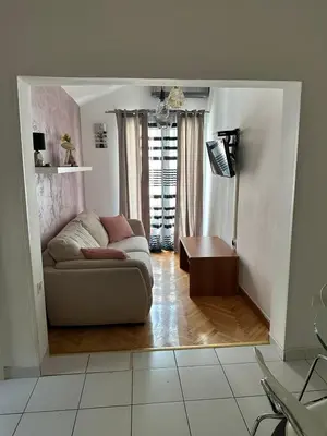 a living room with a couch and a table at Apartman Mimi in Budva