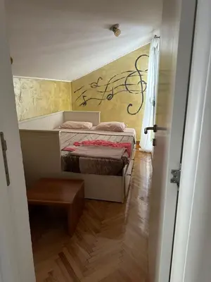 a small bedroom with a bed in a room at Apartman Mimi in Budva