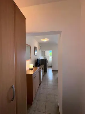 a hallway leading to a kitchen with a kitchen at Casa Loza in Sveti Stefan