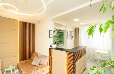 a living room with a couch and a table at 7 Hills Rooms in Podgorica