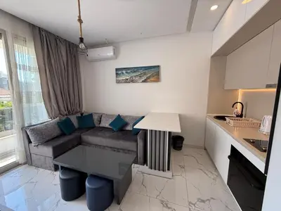 a living room with a couch and a table at Aura Tower in Rafailovici