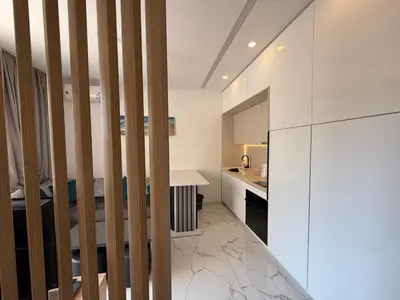 a kitchen with white walls and a white counter at Aura Tower in Rafailovici