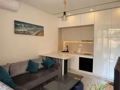 a living room with a couch and a kitchen at Aura Tower in Rafailovici