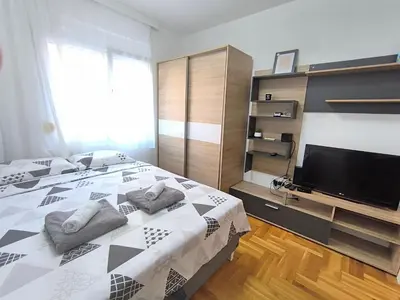 a bedroom with a bed and a television in it at Apartment 365 in Podgorica