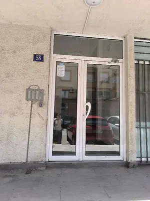 a glass door of a building with a parking meter at Apartment 365 in Podgorica