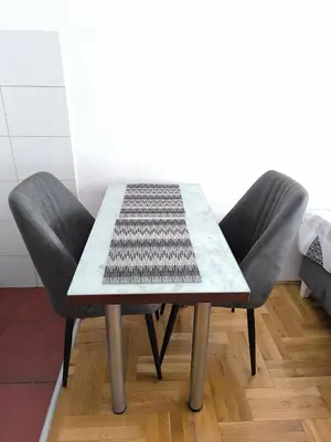 a table and two chairs in a room at Apartment 365 in Podgorica
