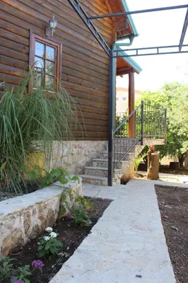 a house with a stone walkway next to a building at Lotos - vikendica 1 in Bar