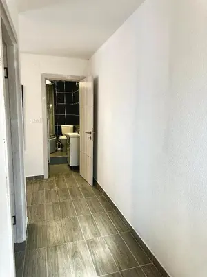 an empty hallway with a bathroom and a toilet at Uros Apartments in Tivat