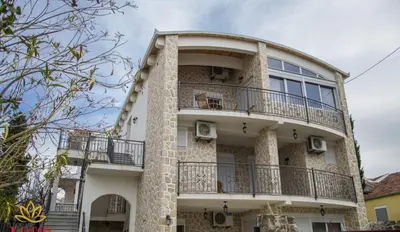 a building with a balcony on the side of it at Lotos - family stan in Bar