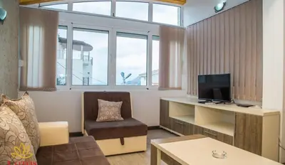 a small living room with a desk and a television at Lotos - family stan in Bar