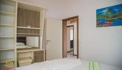 a bedroom with a bed and a closet with shelves at Lotos - family stan in Bar