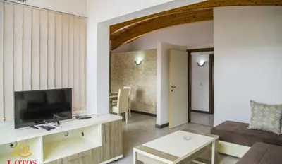 a living room with a couch and a television at Lotos - family stan in Bar