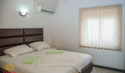 a bedroom with a bed with towels on it at Lotos - family stan in Bar