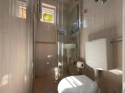 a bathroom with a toilet and a shower and a sink at Private double room in the Old Town in Budva