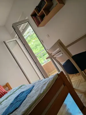 a bedroom with a bunk bed and a window at Apartments Lučijana in Budva