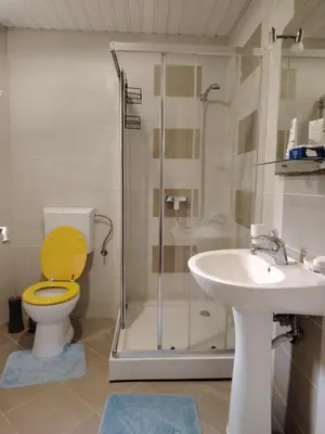a bathroom with a yellow toilet and a sink at Apartments Lučijana in Budva