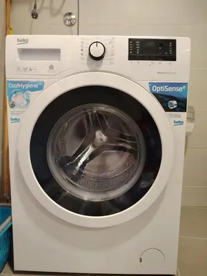 a white washing machine is in a room at Apartments Lučijana in Budva