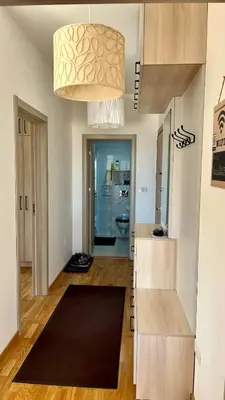 a kitchen with a large chandelier hanging from the ceiling at Penthouse Becici in Budva