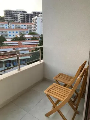 a wooden chair sitting on top of a balcony at Montesin cozy studio in Budva
