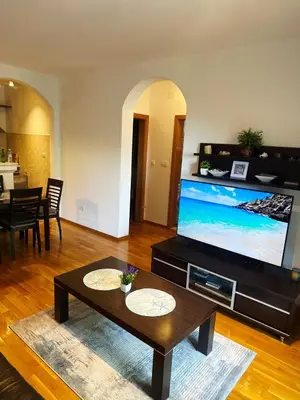 a living room with a large flat screen tv at Sun Apartment in Petrovac na Moru
