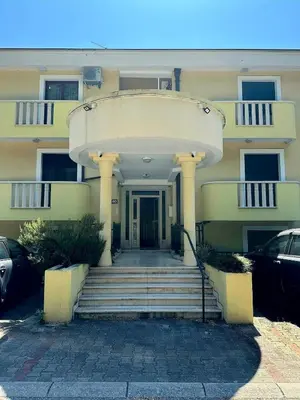 a building with a staircase leading to the front door at Sun Apartment in Petrovac na Moru