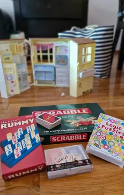 a group of books sitting on a table with toys at Sun Apartment in Petrovac na Moru