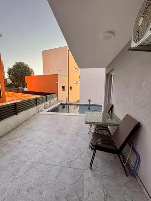a patio with a table and chairs on top of a building at Apartment AB in Bar