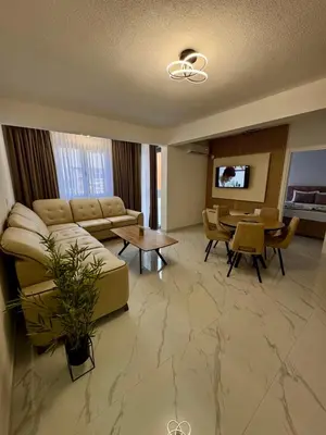 a living room with a couch and a table at Apartment AB in Bar