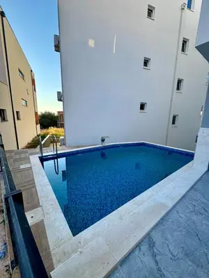 a swimming pool in front of a building at Apartment AB in Bar