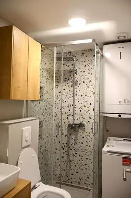 a bathroom with a shower with a toilet and a sink at Fighen Apartment in Budva